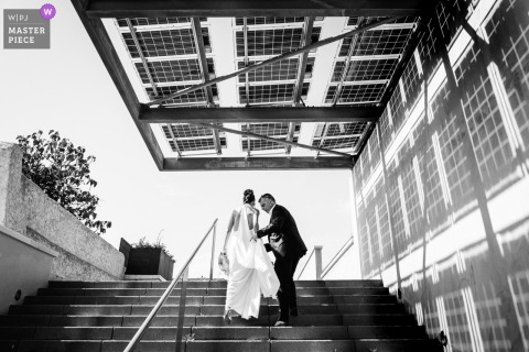 Bride and her father share a tender moment on outdoor stairs in Pezenas, France, before the wedding ceremony.