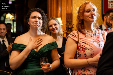 Bridesmaids at Bar George, Montreal, get emotional as they watch the wedding couple read heartfelt vows during ceremony.