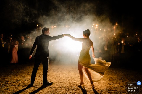 At The Station House, Kilmessan, Ireland, the couple shares their first dance surrounded by guests holding glowing sparklers in celebration.