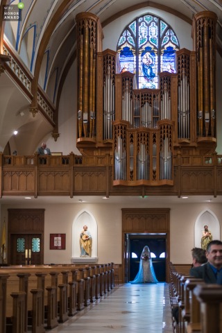 Bride Glows Blue As Cathedral Doors Open At Cathedral Of St Mary Cheyenne Wyoming Bride glows electric blue as cathedral doors open at Cathedral of St. Mary, Cheyenne, Wyoming, beginning her aisle walk ceremony.