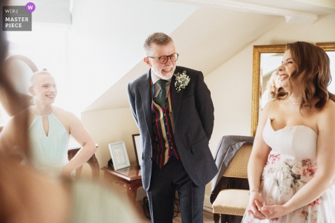 The happy father of the bride smiles warmly at Warwick House, Southam, UK, radiating pride and joy before the ceremony.
