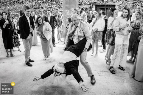 Couple Dances Joyfully During Cocktail Hour at Domaine de Granoupiac Wedding Celebration A candid documentary photo of a couple dancing joyfully during cocktail hour at Domaine de Granoupiac, wedding celebration.