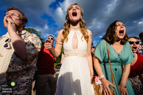   Laughter fills the air outside at Château des Pertonnières as the bride lets loose with a playful howl during a spirited singing contest with her guests.