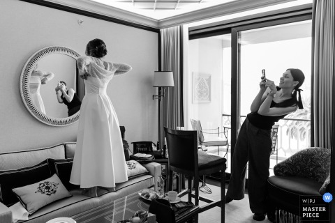 The bride gets ready at Çırağan Palace Kempinski, Istanbul, adjusting her veil as natural light softly illuminates her.