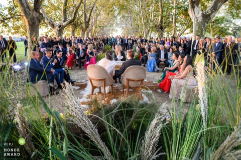 Wedding Ceremony Unfolds With Traditional Elegance Before Gathered Friends And Family In Rosario Argentina In the vibrant city of Rosario, Argentina, the wedding ceremony unfolds with traditional elegance, capturing the solemn and reverent union of the couple before their gathered friends and family.