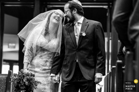 Bride and Groom Enter Wedding Ceremony Together at Congregation Etz Chaim At Congregation Etz Chaim, a bride and groom enter their wedding ceremony together. The award-winning photograph highlights the photographer's skill at documenting this unique tradition and the pure joy of the moment.