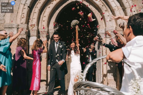 At an Old World Church in Porto, Portugal, a bride and groom celebrate their exit from the ceremony. The award-winning photo highlights the photographer’s skill at documenting the pure joy and celebration of a wedding day.