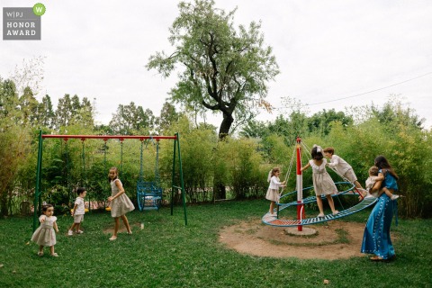 A dedicated caregiver supervises a group of children at the Torre de Mirahuerta venue in Zaragoza, Spain, allowing the parents to fully relax and enjoy the wedding reception nearby.