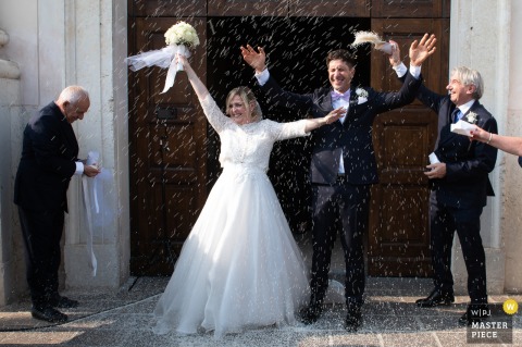 At Chiesa di San Pietro in Viadana, Italy, newlyweds exit the church under a shower of rice. The award-winning photo highlights the photographer's skill at documenting the unbridled joy and celebration of the moment.