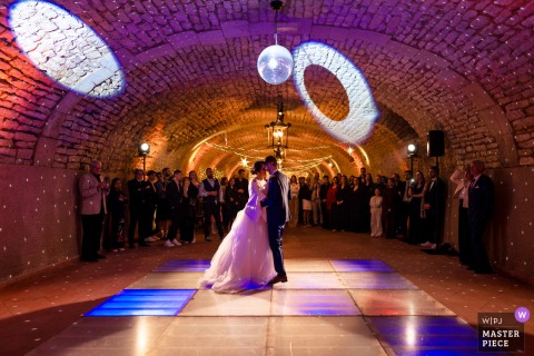 Newlyweds Share First Dance in Vaulted Cellar at Château de Boucq, France Historic Venue At the Château de Boucq in France, newlyweds share their first dance in the vaulted cellar. The award-winning photo highlights the photographer’s skill at documenting intimate, romantic moments in a unique and historic setting.