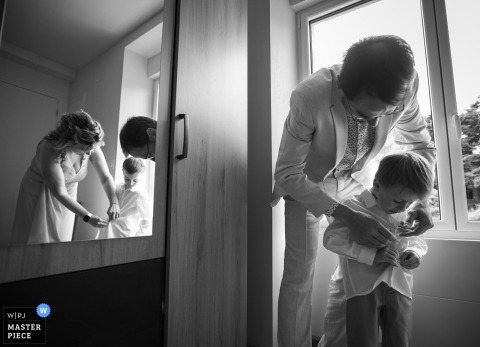 At a home in Ille-et-Vilaine, Brittany, the bride and groom's children get ready with their aunt and uncle. The award-winning photo highlights the photographer's ability to document the candid, heartwarming moments of a family wedding.