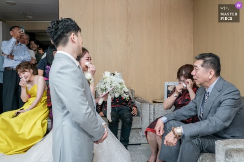 At the Taipei Marriott Hotel, a bride, her sister, and her mother all cry during a traditional farewell ceremony. The winning photograph highlights the photographer's skill at capturing the raw, unscripted emotions of a wedding day.