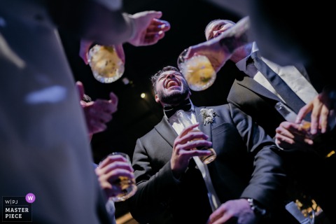 In Sao Paulo, a low-angle shot from the dance floor captures a group of men holding drinks during a lively party. The winning image demonstrates the photographer's ability to document candid moments with a unique perspective.