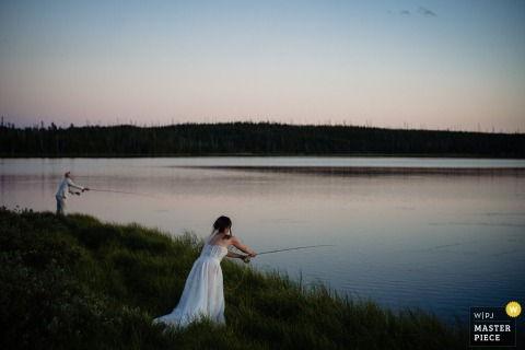 In Yellowstone, a couple fly fishes in low light as the sun sets over the water. The award-winning photo, a testament to the photographer’s documentary skills, captures a quiet, intimate moment between the couple.