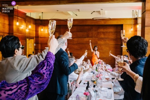 At Town Hall Hotel in London, the photographer captures the maid of honor toasting the couple, expertly freezing heartfelt emotion and celebratory spirit with a keen eye for candid storytelling moments.
