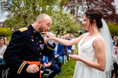 At a ceremony in 's-Hertogenbosch, Noord Brabant, the photographer captures the meaningful moment of the couple putting on the rings, expertly highlighting a heartfelt connection with humor.