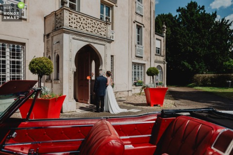 Bride And Her Father Prepare For The Civil Ceremony In Front Of Meuse Town Hall France In front of the town hall in Meuse, the bride and her father prepare to enter for the civil ceremony while the wedding car sits parked nearby in wait.