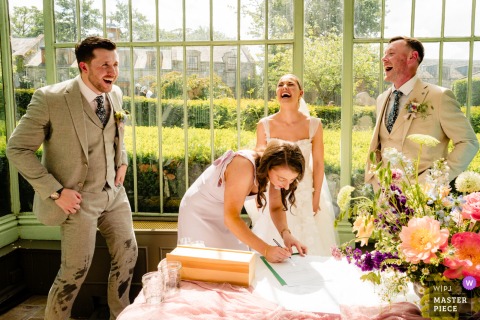 Guests Laugh As Groom’s Sweat-Soaked Pants Spark Humor At Cliff At Lyons Ireland Wedding At Cliff at Lyons, Ireland, the photographer captures everyone laughing as the groom’s suit pants are soaked with sweat after a hot ceremony, perfectly highlighting candid humor and shared joy with impeccable timing.