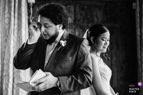 Groom at The Pinery at The Hill wiping tears while reading his private wedding vows.