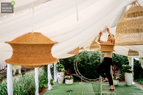 During a busy morning at the Nad Potokiem restaurant in Lancashire, family and friends gather to hand-assemble charming DIY decorations to personalize the wedding reception space.