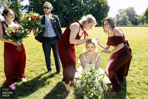 Bridesmaids help a bride with her veil at Château de Montplaisant.