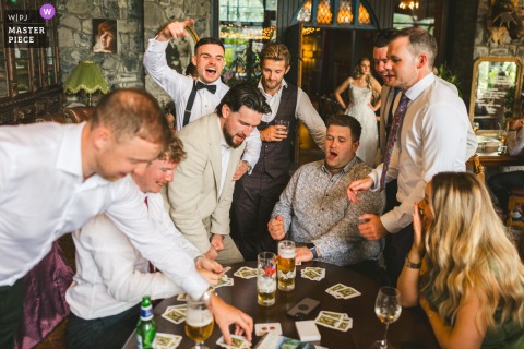 Groom and friends play cards at their Mount Druid reception.