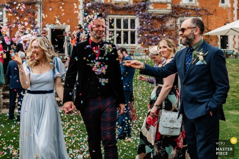 Thicket Priory, North Yorkshire, England: Bride and groom covered in confetti.