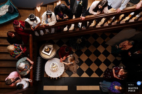 Aerial view of bride and groom cutting their wedding cake at Thicket Priory, North Yorkshire.