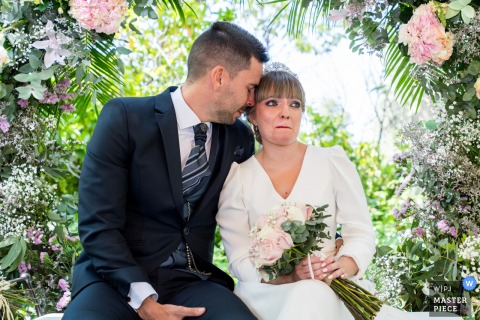 Emotional bride holding back tears at Hotel HO Jaén, Spain.