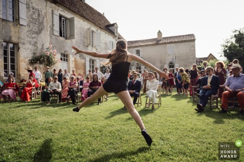 At Domaine de la Léotardie in Dordogne, a young guest performs a moving dance solo for the bride, creating a graphic and emotional scene during the elegant reception festivities.