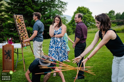 Wedding guests engage in lively outdoor lawn games during the cocktail hour at La Grange aux Fées in Autrans, France, creating a spirited and interactive atmosphere for everyone attending.