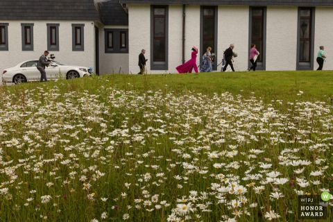 The bride and her wedding party arrive at Falcarragh Church in Donegal, gathered together in anticipation just moments before the start of the formal marriage ceremony in Ireland.