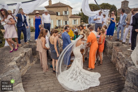 Bride Focuses Intently On Signing The Official Marriage Register During Elegant Legal Proceedings In Lectoure France Seated at a table within the elegant Castelnau in Lectoure, France, the bride focuses intently on signing the official marriage register to finalize the legal proceedings of her wedding.