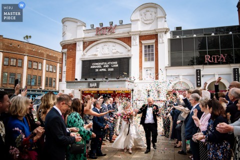 Outside the legendary Ritzy in Brixton, confetti fills the air as the couple exits Southwark Town Hall. The photographer’s technical skill brilliantly captures the exuberant atmosphere of this iconic moment.