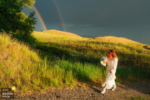 In a private field in Chico Springs, Montana, the bride walks past double rainbows to her ceremony. The photographer’s technical skill beautifully captures this memorable wedding landscape.
