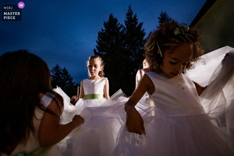 At Le Chateau in Kalama, Washington, flower girls dance during the reception as dramatic Pacific Northwest storms brew outside, adding energy and atmosphere to the celebration.