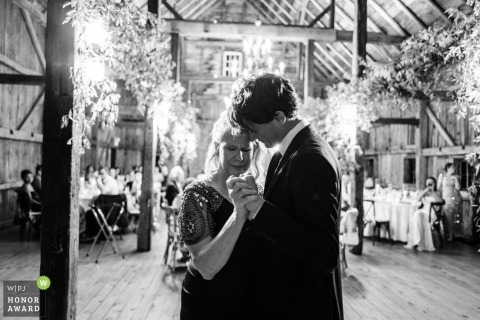 A Mother And Son Share A Touching Dance At The Barn At Walnut Hill In Maine During the reception at The Barn at Walnut Hill in Yarmouth, Maine, a mother and son share a touching dance, surrounded by the warmth of family and friends.
