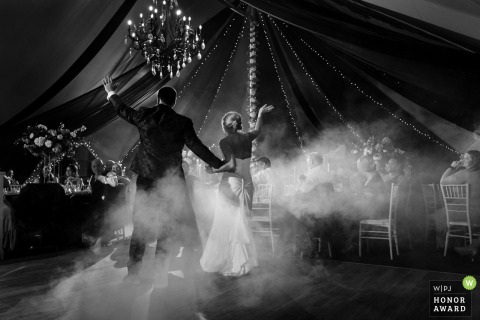 The wedding reception in Missouri comes alive during the couple’s first dance, surrounded by guests who share in the joyful moment.