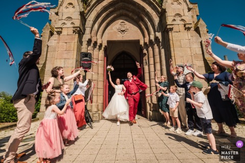 At the church in Rennes, Ille-et-Vilaine, Brittany, France, the newlyweds exit to lively Ricchi e Poveri music, captured from a dramatic low and wide camera angle.