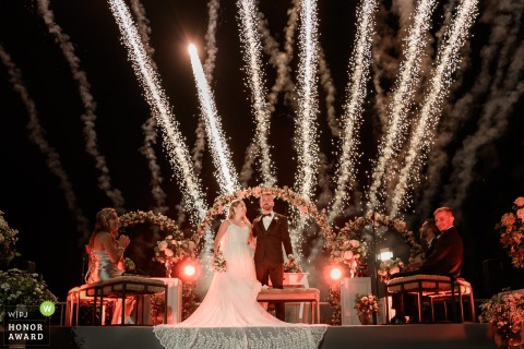 Fireworks Light Up The Night Sky During A Dramatic Sendoff At Punta Barranca In Rosario Argentina Fireworks light up the sky at Punta Barranca venue in Rosario, Argentina, as the bride and groom depart from the ceremony, creating a dramatic and joyful sendoff.