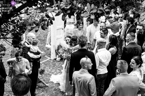 Corte San Ruffillo Relais, Dovadola Wedding: Bride Smiles Receiving Compliments From Guests At Corte San Ruffillo Relais in Dovadola, Italy, the bride stands joyfully among the guests, smiling warmly as she receives compliments and well wishes during the celebration.