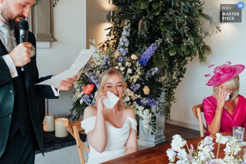 At Thorpe Garden in Staffordshire, UK, the bride and her mother wipe their eyes with tissues during the groom’s heartfelt wedding speech.
