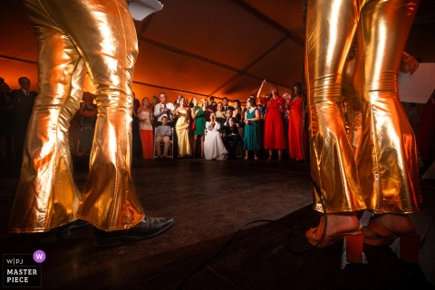 At Château Cousine, a lively disco atmosphere energizes the wedding celebration, with vibrant lights and music setting the scene for an unforgettable party.