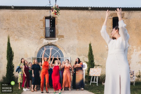 Château de Campet in Landes, France, is the scene as the bride tosses her bouquet, which gets tangled in the garland lights before landing safely in a guest’s arms.