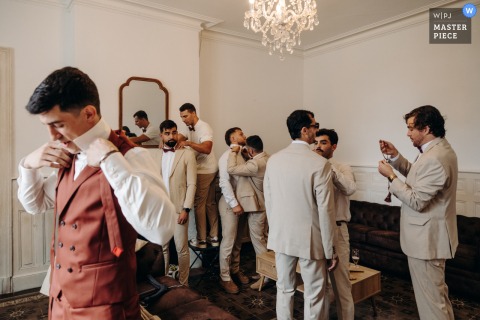 At Domaine du Mey in Gers, the groomsmen get ready alongside the groom, sharing camaraderie and excitement as they prepare for the wedding ceremony.