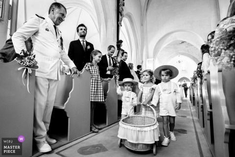 At the church in Ars-en-Ré, France, the bridal procession enters the sanctuary, marking the formal and emotional beginning of the wedding ceremony.