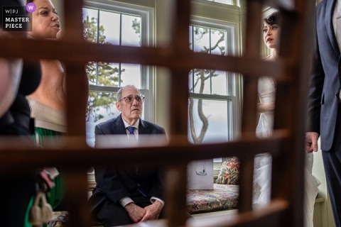At Winslow Waterfront Estate in Orleans, MA, a father shares a quiet, emotional moment, pausing to reflect as the wedding preparations continue around him.