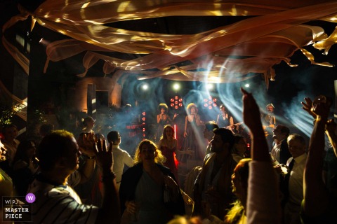 At Odera Hotel in Tinos, Greece, the wedding band SuperPop performs during a lively wedding celebration, providing live music and entertainment for guests.