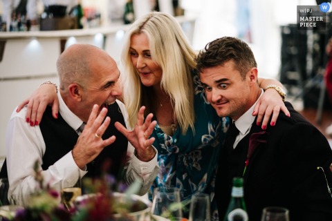 In Goudhurst, Kent, the groom’s sister warmly welcomes one of the groom’s loved ones to the family, sharing a heartfelt moment during the celebration.