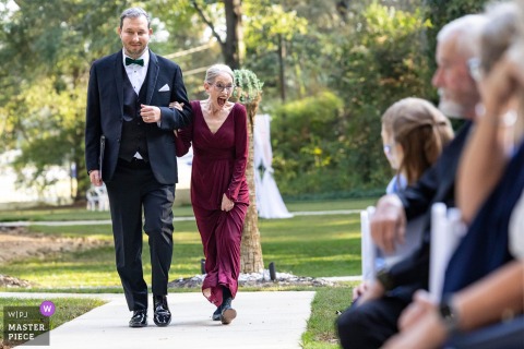 Powder Springs, Georgia Palms Wedding: Bride’s Mother Emotional Walking Down Aisle At Georgia Palms in Powder Springs, Georgia, the mother of the bride reacts with emotion and warmth to guests as she walks down the aisle to the ceremony.